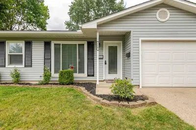 a house with a white garage at Private Ranch- Entire Home - Hot Tub - Pets & Kids Welcome - King Bed - Fenced Backyard - Free WiFi in Gahanna