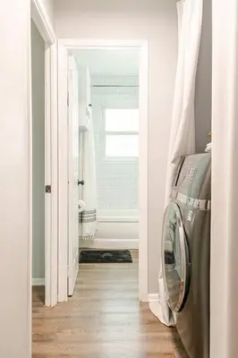 a bathroom with a washing machine in a room at Private Ranch- Entire Home - Hot Tub - Pets & Kids Welcome - King Bed - Fenced Backyard - Free WiFi in Gahanna