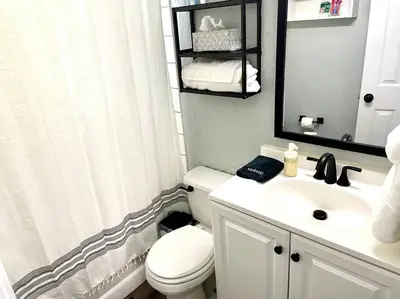 a bathroom with a white toilet and a sink at Private Ranch- Entire Home - Hot Tub - Pets & Kids Welcome - King Bed - Fenced Backyard - Free WiFi in Gahanna