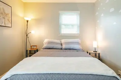 a bedroom with a large bed with two night stands at Private Ranch- Entire Home - Hot Tub - Pets & Kids Welcome - King Bed - Fenced Backyard - Free WiFi in Gahanna