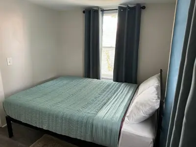 a small bedroom with a bed with a window at Downtown Willoughby Historic District Gem #2 in Willoughby