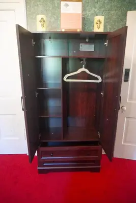 a wooden cabinet with a hanger in a room at Main Oak Manor in Gallipolis