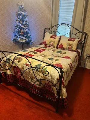 a bedroom with a christmas tree and a bed at Main Oak Manor in Gallipolis