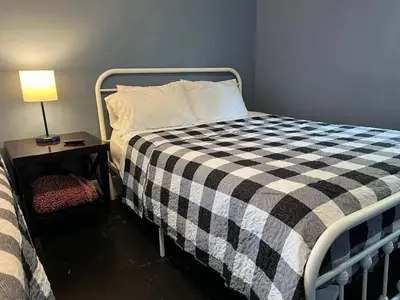 a bedroom with a bed with a black and white checkered blanket at House with 10 Beds Sleeps 16 free Driveway Parking in Cincinnati