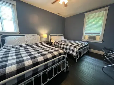 two beds in a room with two windows at House with 10 Beds Sleeps 16 free Driveway Parking in Cincinnati