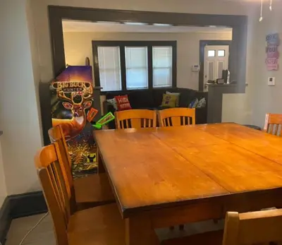 a dining room with a wooden table and chairs at House with 11 Beds Sleeps 14 with Off Street Parking in Akron