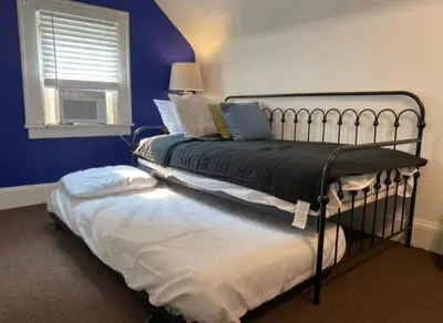 a bedroom with a bed and a window at House with 11 Beds Sleeps 14 with Off Street Parking in Akron