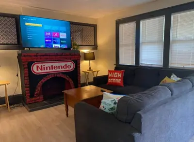 a living room with a couch and a fireplace at House with 11 Beds Sleeps 14 with Off Street Parking in Akron