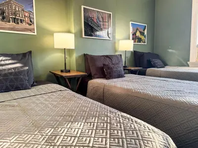 a hotel room with two beds and a couch at Spacious 3 Bedroom Sleeps 12 with 7 Beds plus Parking in Dayton