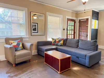 a living room with a blue couch and two chairs at Spacious 3 Bedroom Sleeps 12 with 7 Beds plus Parking in Dayton
