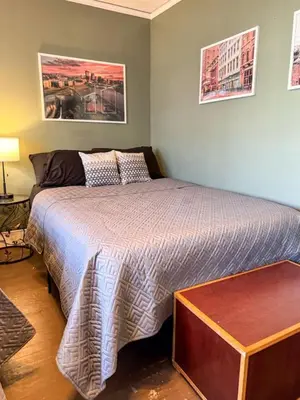 a bedroom with a bed and a night stand at Spacious 3 Bedroom Sleeps 12 with 7 Beds plus Parking in Dayton