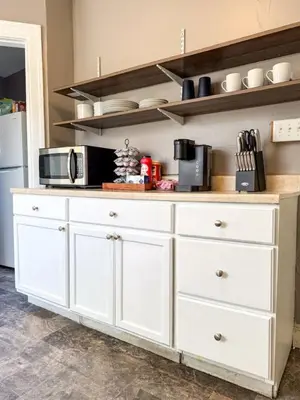 a kitchen with white cabinets and a counter with a microwave at Spacious 3 Bedroom Sleeps 12 with 7 Beds plus Parking in Dayton