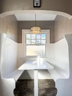 a white bench in a room with a window at Spacious 3 Bedroom Sleeps 12 with 7 Beds plus Parking in Dayton