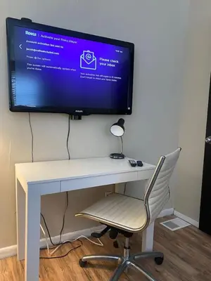 a computer monitor on a desk with a chair at Dayton with 6 Beds Sleeps 8 4 Bedrooms plus WIFI in Dayton