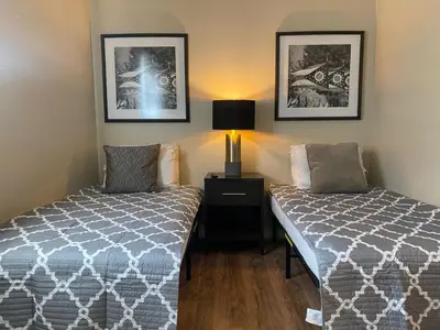 a bedroom with two beds and a lamp and pictures at Dayton with 6 Beds Sleeps 8 4 Bedrooms plus WIFI in Dayton