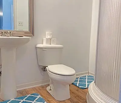 a bathroom with a white toilet and a sink at Dayton with 6 Beds Sleeps 8 4 Bedrooms plus WIFI in Dayton