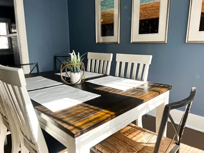 a dining room table and chairs with a wooden table at 3 Bedroom House, 7 Beds, Sleeps 10, Dayton in Dayton