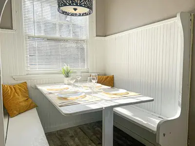 a white table with wine glasses and plates on it at 3 Bedroom House, 7 Beds, Sleeps 10, Dayton in Dayton