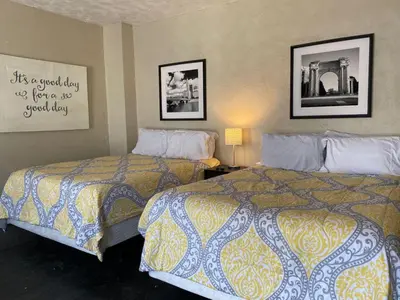 a hotel room with two beds and a picture on the wall at Dayton with 5 Beds Sleeps 10 2 Bedrooms plus WIFI in Dayton