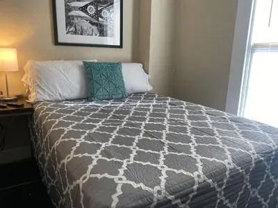 a bedroom with a bed with a gray and white comforter at Dayton with 5 Beds Sleeps 10 2 Bedrooms plus WIFI in Dayton