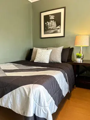 a bedroom with a bed and a table with a lamp at Sleeps up to 20 in Dayton with 6 Bedrooms plus 2 Full Kitchens in Dayton