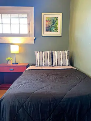 a bedroom with a bed and a window and a lamp at Sleeps up to 20 in Dayton with 6 Bedrooms plus 2 Full Kitchens in Dayton