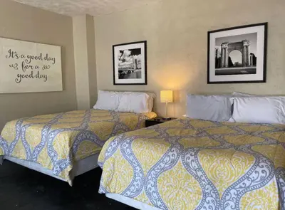 a hotel room with two beds and a picture on the wall at Sleeps 16 with 11 Beds 6 Bedrooms plus WIFI in Dayton