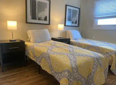 a hotel room with two beds and two lamps at Sleeps 16 with 11 Beds 6 Bedrooms plus WIFI in Dayton