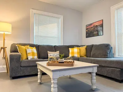 a living room with a couch and a coffee table at Spacious 4 bedroom Sleeps 8 with 7 Beds plus Parking in Dayton