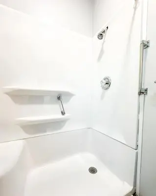 a white bathroom with a shower and a sink at Spacious 4 bedroom Sleeps 8 with 7 Beds plus Parking in Dayton