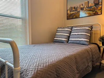 a bedroom with a bed with two pillows and a window at Spacious 4 bedroom Sleeps 8 with 7 Beds plus Parking in Dayton