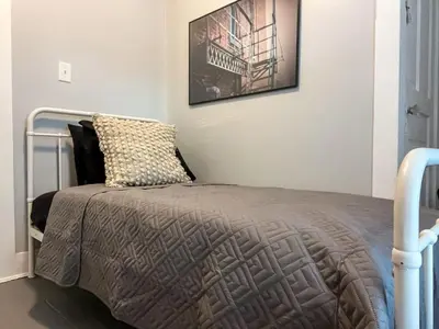 a bedroom with a bed with a poster on the wall at Spacious 4 bedroom Sleeps 8 with 7 Beds plus Parking in Dayton