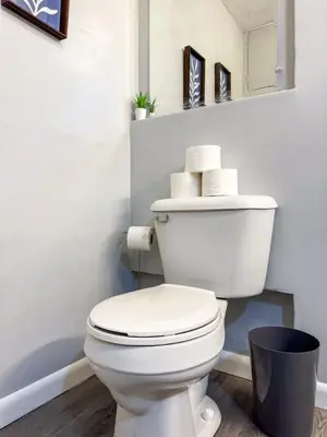 a white toilet in a bathroom with some towels at Spacious 4 bedroom Sleeps 8 with 7 Beds plus Parking in Dayton