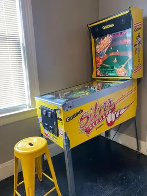 a yellow pinball machine with a yellow stool next to it at Rare Find Sleeps 16 with 9 Beds 6BR plus WIFI in Cincinnati