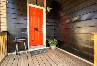 a red door on the side of a house at Rare Find Sleeps 16 with 9 Beds 6BR plus WIFI in Cincinnati