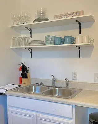 a kitchen counter with a sink and shelves at Crew Housing Sleeps 8 with 6 Beds plus 4 Bedrooms in Dayton