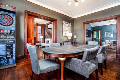 a dining room with a table and chairs at Downtown Mansion with 7 Bedrooms 2.5 Baths Sleeps 20 in Cincinnati