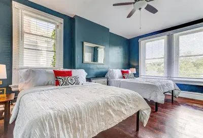 a bedroom with two beds and a ceiling fan at Downtown Mansion with 7 Bedrooms 2.5 Baths Sleeps 20 in Cincinnati