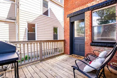 a porch with a hammock and a piano on a house at Downtown Mansion with 7 Bedrooms 2.5 Baths Sleeps 20 in Cincinnati