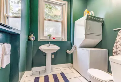 a green bathroom with a toilet and a sink at Downtown Mansion with 7 Bedrooms 2.5 Baths Sleeps 20 in Cincinnati