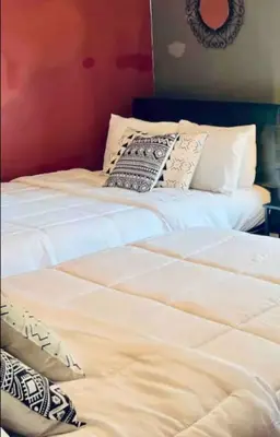 two beds sitting next to each other in a room at Downtown Home 10 Beds Sleeps 14 w Parking in Cincinnati