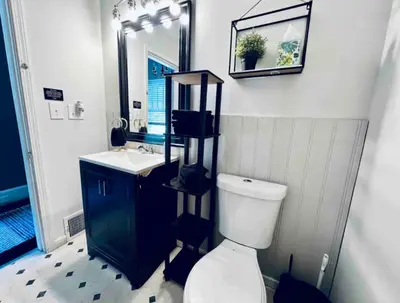a bathroom with a toilet and a sink and a mirror at Downtown Home 10 Beds Sleeps 14 w Parking in Cincinnati