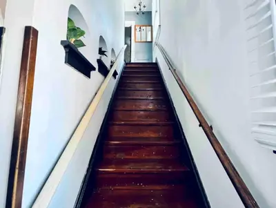 a staircase in a house with wooden floors at Downtown Home 10 Beds Sleeps 14 w Parking in Cincinnati