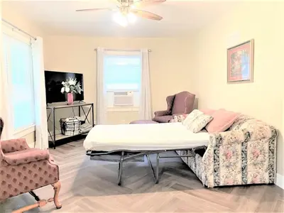 a room with a bed and two chairs in it at Walnut - Family Neighborhood, Pet Friendly in Paulding