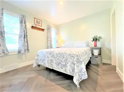 a bedroom with a bed with a white bedspread at Walnut - Family Neighborhood, Pet Friendly in Paulding