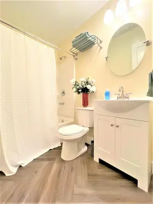 a bathroom with a toilet and a sink and a mirror at Walnut - Family Neighborhood, Pet Friendly in Paulding