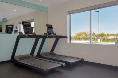 a gym with a treadmill in a room with a window at Tru By Hilton Anderson in Anderson