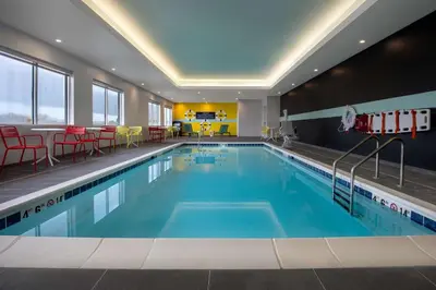 a pool in a hotel with chairs and a table at Tru By Hilton Anderson in Anderson