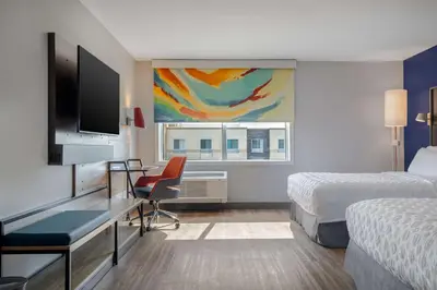 a hotel room with two beds and a desk with a television at Tru By Hilton Anderson in Anderson