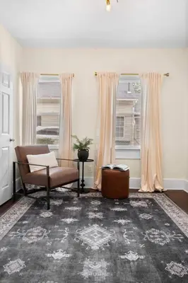 a living room with a chair and a window at Charming Home in Cleveland 3215 in Ohio City